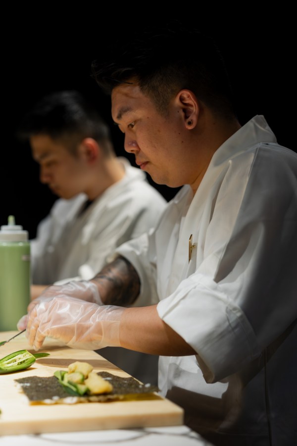 Chefs preparing service behind the pass at Okane Sushi